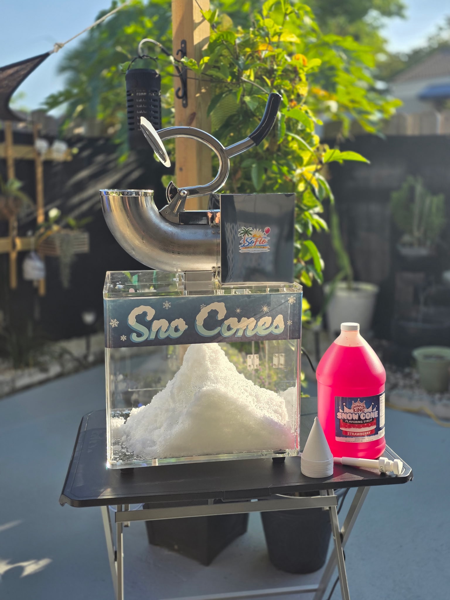 Sno-cone machine shaving ice for colorful flavored snow cones